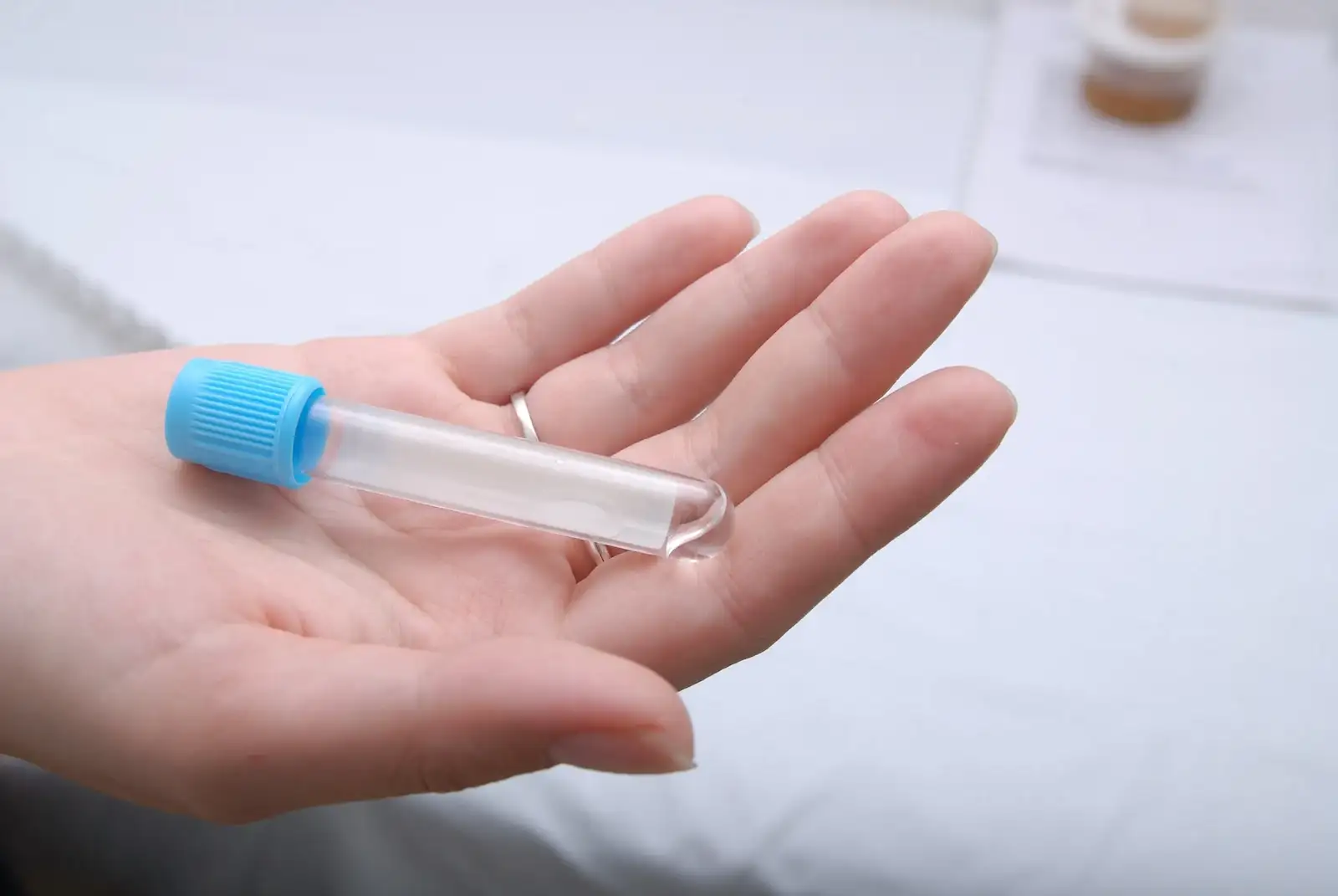 hand outstretched with a test tube in it to determine how long drugs stay in your system