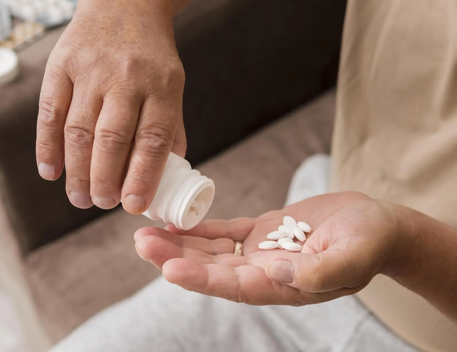 How Long Does Concerta Last? A person pouring white pills into their hand.