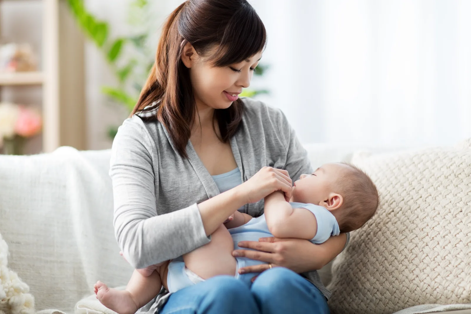 woman cradling young baby in her arms